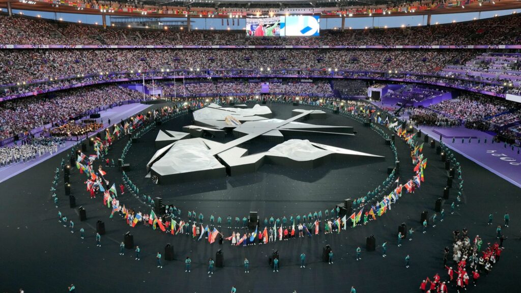 Flag bearers march during the 2024 Summer Olympics closing ceremony at the Stade de France, Sunday, Aug. 11, 2024, in Saint-Denis, France. (AP Photo/Kin Cheung)