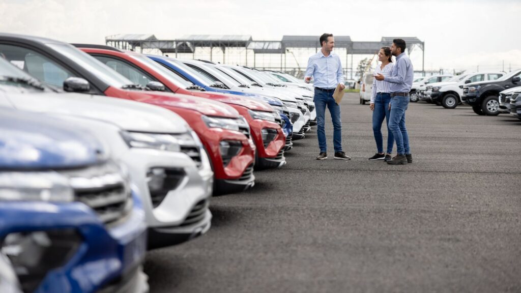 Salesman showing cars to a couple at the dealership. File pic: iStock