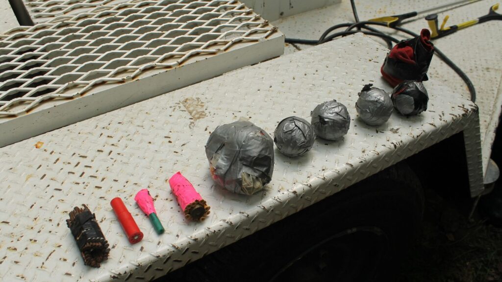 The man tries to explode 14 explosive devices while being arrested by police